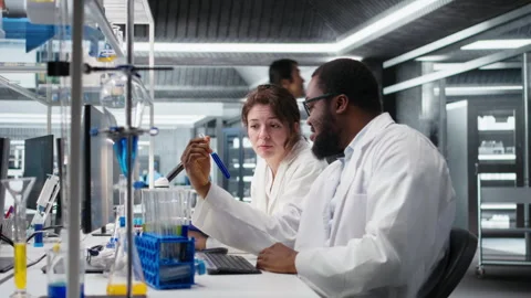 Team of lab technicians using chemical solutions, creating mixtures Stock Footage 320147266