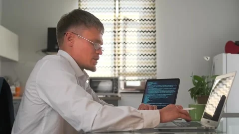 Team lead reviews documentation on a tablet and smiles during a video call. Stock Footage 296220302