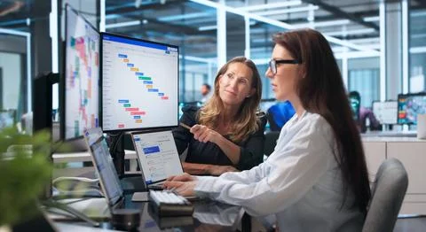 Team Leader Points At Timeline While Colleagues Discuss Project Progress Toge Stock Photos