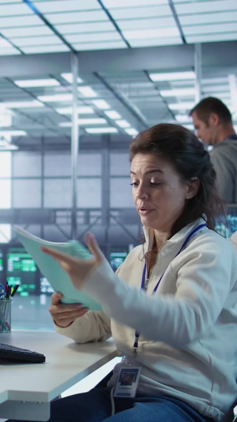 Team leader reading paperwork files on artificial intelligence tech Stock Footage 319547182