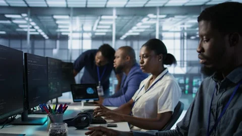 Team leader in server room teaching intern how to monitor performance Stock Footage 319575136
