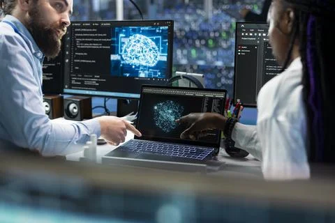 Team leader teaching intern to code in data center, updating AI 스톡 사진