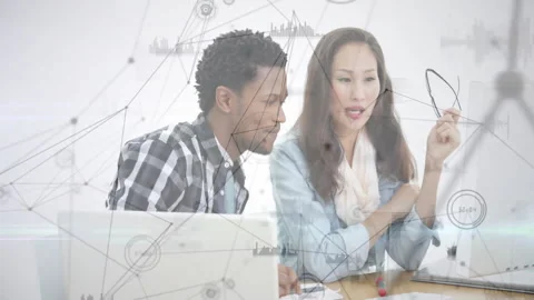Team leaning forward and pointing, generating animated data overlay during 動画素材 311916299