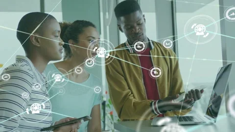 Team leaning by laptop as man tapping tablet triggers network nodes overlay Stock Footage 332901791