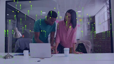 Team leaning over docs, pointing-tapping laptop, checking phone, green code on Stock Footage 332981689