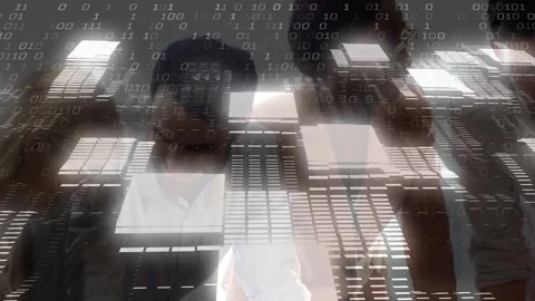 Team leaning over screen reading data, sparking binary-grid rising and hiding Stock Footage 334036693