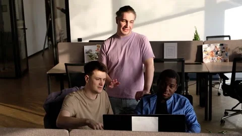 Team is looking for bug fixes. Programmers working in the office of a software Video stock 235855415