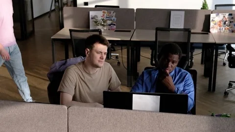 Team is looking for bug fixes. Programmers working in the office of a software Video stock 235855433