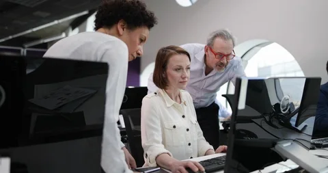 Team looking at computer in an office Stock Footage 86517136
