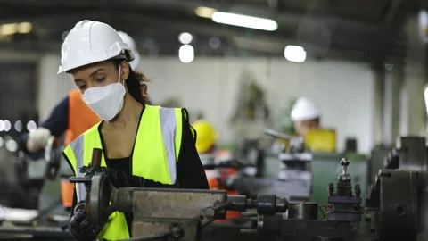 Team Machine engineer wearing helmet And mask while working in factory Industry. Stock Footage 154259396