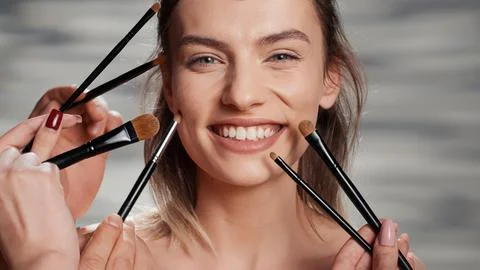 Team of make up artists doing makeover on beauty model 写真素材