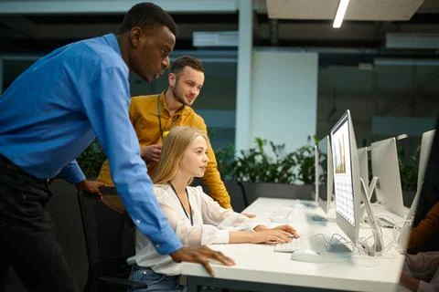 Team of managers looks on screen in IT office Stock Photos