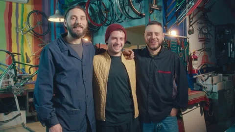 Team of Mechanics Posing Together on Camera in Bicycle Workshop Stock Footage 256593410