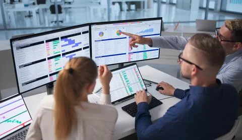 Team Of Medical Billing Analysts Coding And Reviewing Spreadsheets Together. Stock-Fotos