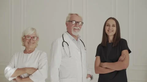 Team of medical professionals looking at camera, smiling in hospital lobby. Stock Footage 141224438