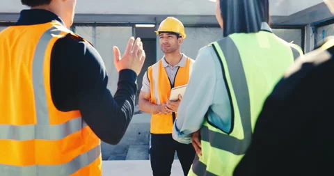 Team, meeting and builder with hands raised for question, construction training Stock Footage 345646562