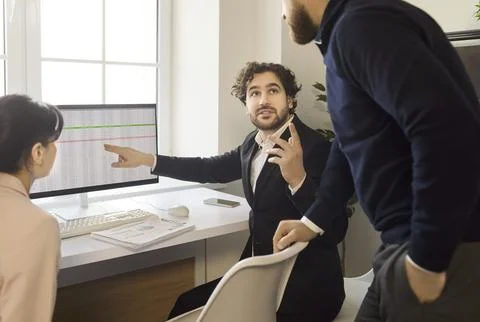 Team meeting as manager presents data insights to colleagues at modern office Stock Photos