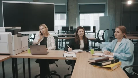 Team members collaborating in a modern office while handling documents Stock-Footage 318523341