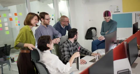 Team members discuss ideas and projects in a bright office while collaborating Stock Footage 343025991