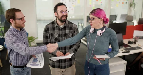 Team members discuss project ideas in office as they collaborate on business Stock Footage 343016876