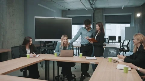 Team members discuss project tasks and ideas during a meeting Stock-Footage 326325268