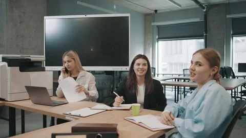 Team members discuss project updates and share ideas in a modern office space Stock Footage 326324483