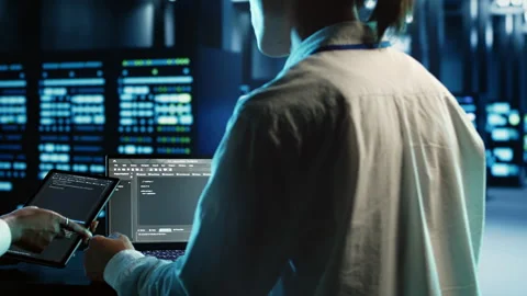 Team members programming in data center Stock Footage 249562668