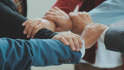 Team members stack hands showing concept of unity and teamwork Stock Footage 325421152