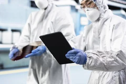 Team of microchip system architects inspecting semiconductor production Stock Photos