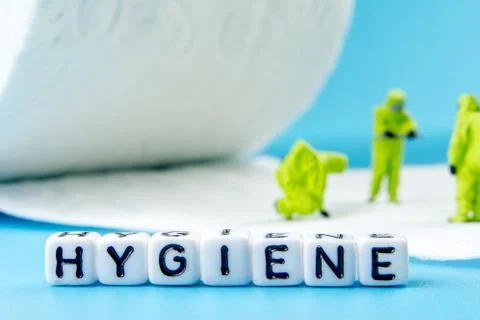 A team of miniature figurines checking a cleanliness of toilet paper as a sym Stock Photos