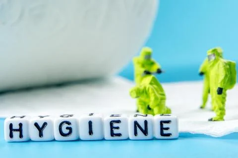 A team of miniature figurines checking a cleanliness of toilet paper as a sym Stock Photos