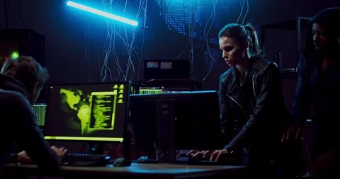 Team of mixed-races hackers commiting a cyber crime and then running away from Video stock 124350728