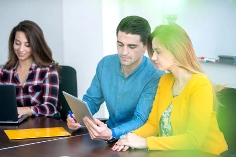 Team of motivated people using various devices at a startup metting Stock Photos