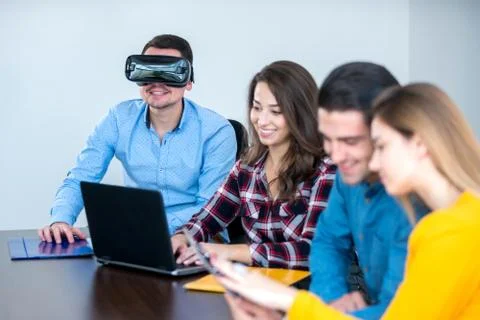 Team of motivated people using various devices at a startup metting Stock Photos