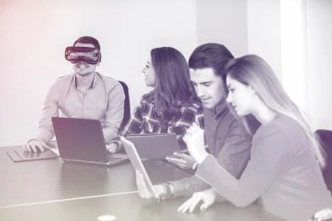 Team of motivated people using various devices at a startup metting Stock Photos
