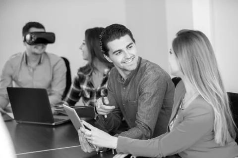 Team of motivated people using various devices at a startup metting Stock Photos