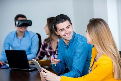 Team of motivated people using various devices at a startup metting Stock Photos