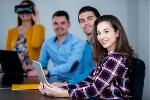 Team of motivated people using various devices at a startup metting Stock Photos