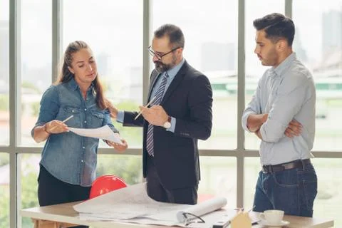 Team of multiethnic architects working on construction plans in meeting room. Foto stock