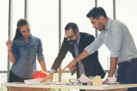 Team of multiethnic architects working on construction plans in meeting room. Foto stock