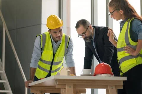 Team of multiethnic architects working on construction plans in meeting room. Foto stock