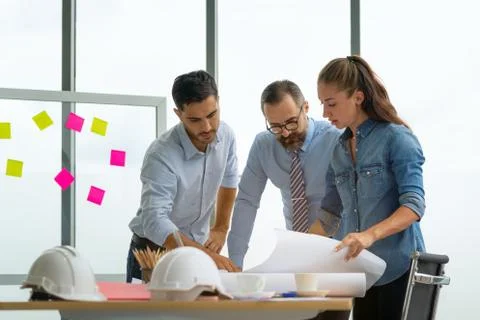 Team of multiethnic architects working on construction plans in meeting room. Foto stock