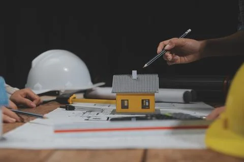 Team of multiethnic architects working on construction plans in meeting roo.. Stock Photos