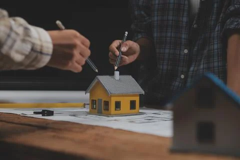 Team of multiethnic architects working on construction plans in meeting roo.. Stock Photos