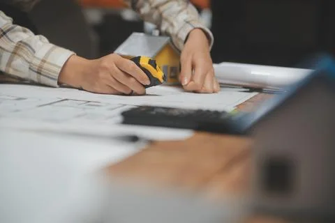 Team of multiethnic architects working on construction plans in meeting roo.. Stock Photos