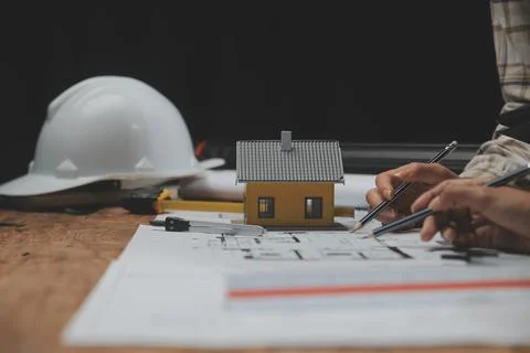 Team of multiethnic architects working on construction plans in meeting roo.. Stock Photos