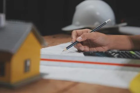 Team of multiethnic architects working on construction plans in meeting roo.. Stock Photos