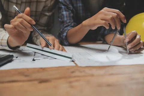 Team of multiethnic architects working on construction plans in meeting roo.. Stock Photos