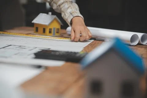 Team of multiethnic architects working on construction plans in meeting roo.. Stock Photos