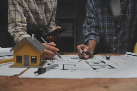 Team of multiethnic architects working on construction plans in meeting roo.. Stock Photos